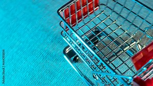 empty shopping cart rotating on a board. RGB Flashlight effect. 4k video capture