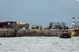 Cargo plane slides off runway in Hong Kong, media reports two dead