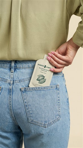 Designing cacao packaging This project was about translating a wellness-driven vision into intentional cacao packaging design. Naked Earth Cacao is a single-serve cacao paste made from organic ingredients and ethically sourced cacao — think almond butter on the go, but cacao. The product design includes squeeze packs and box packaging built around a bold flat vector macaw illustration and hand-drawn one illustrations of cacao and botanicals. Earthy tan, green, and brown tones create a warm, natu