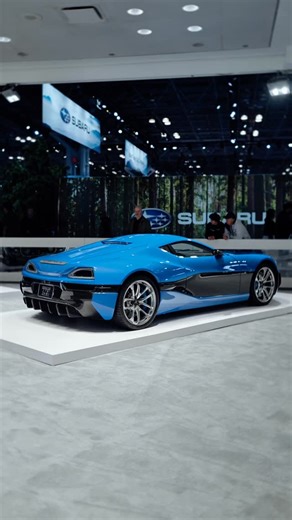 Manhattan Motorcars Inc. on Instagram: "The world’s first fully electric hypercar, the Rimac Concept One. On display at the NY Auto Show 2025 ⚡️ The Concept One was Rimac’s first experimental supercar that, despite the name, is a real car available to the public. It’s all-electric, generating 1224 hp and 1180 lb-ft of torque through four hub-mounted electric motors. This car served as basis prior to the production of the Nevera, with same components and albeit differ from the design. You can see