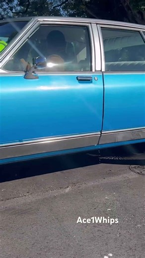 Silver and blue Chevy Caprice on 26’s wire wheels