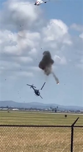 Midair Collision During Takeoff Leaves Helicopter in Flames February 14, 2026 — A shocking midair collision was captured on camera when a commercial aircraft departing a regional airport struck a helicopter moments after liftoff, sending the smaller aircraft spiraling downward in a fiery crash. The footage shows the passenger jet climbing steadily into the sky when, in a split second, it collides with a helicopter flying below and slightly ahead of its ascent path. Debris can be seen breaking aw
