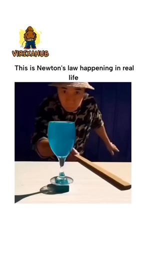 VIREXAHUB on Instagram: "The video depicts a child performing a classic inertia demonstration: swiftly pulling a wooden stick from under a blue glass of liquid balanced on a card, illustrating Newton's first law as the glass remains mostly stationary due to minimal transferred force. Posted by @interesting_aIl , an account sharing eclectic content on history and science, the clip garnered 2.5K likes and nearly 3M views in hours, sparking replies that correctly identify it as the first law while 