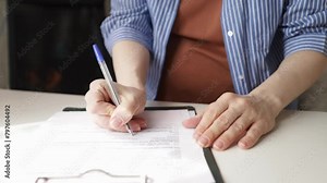 Pregnant woman signing a contract for medical care during pregnancy, maternal health services, and childbirth support