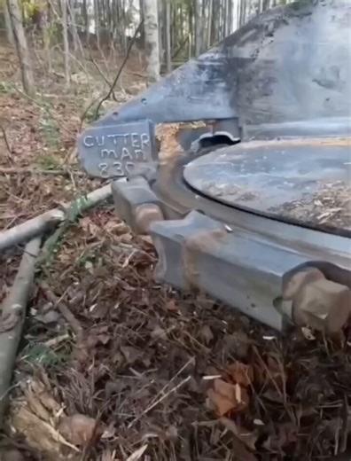 A wood-cutting machine makes a clean slice as the blade moves...