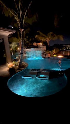 This South Florida Insane Pool shines bright at night. We create a jaw-dropping environment of recreation and relaxation that is 100% customized and unique to every client! #insanepools #lucaslagoons #poolbuilder #pool #backyard | Lucas Lagoons