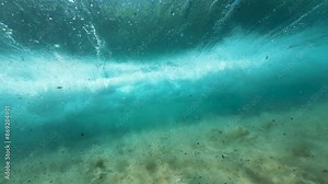 Slow motion of wave vortex with rings. Underwater view of the breaking sea wave with bubble rings forming
