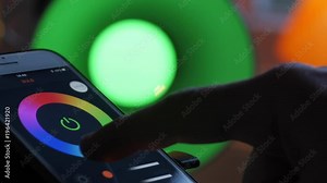 Smart home lighting technology, controlling color of a bulb and scheduling time with a smart phone. Remote controlling light with a phone app. 4k Video