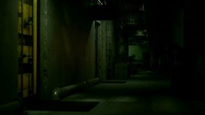 A dimly lit hallway in a dark building