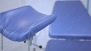 Blue gynecological chair in the women's health clinic. Close-up of an examination chair for pregnant women. The gynecologist's office is slow moving. Doctor's examination of pregnant women