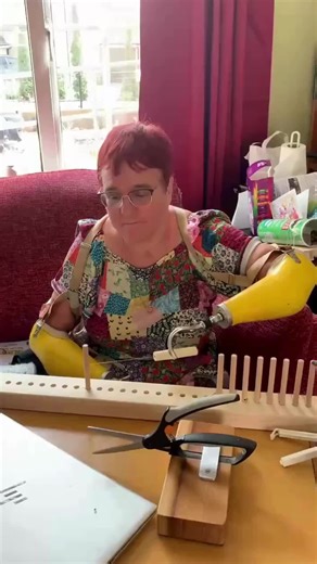 Caroline Coster on Instagram: "Using my prosthetic hooks to warp up my peg loom. By trying out different tools and techniques I have speeded up the process considerably. #quadrupleAmputee #pegLoom #Weaving"