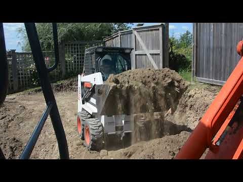 Our Bobcat S70 moving dirt in an extremely tight backyard