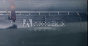 Machine preparing and cutting shapes with laser. Modern tool in heavy industry. Industrial robotic laser cutter cuts plastic parts with great precision. Close up computer cnc. Laser cutting machine at