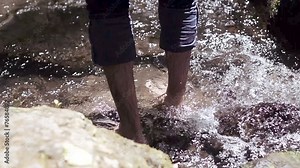 man walks barefoot in the stream - water - stream - river - creek