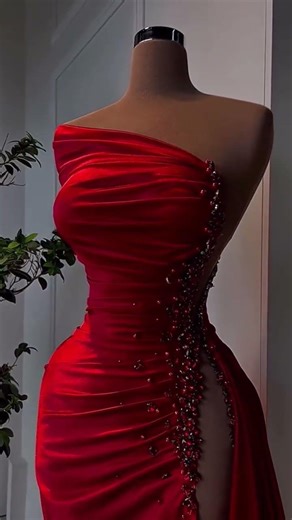 To order this red dress DM A sculpted one shoulder silhouette cut from luminous satin, designed to