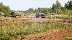 Armoured personnel carrier and a group of soldiers.