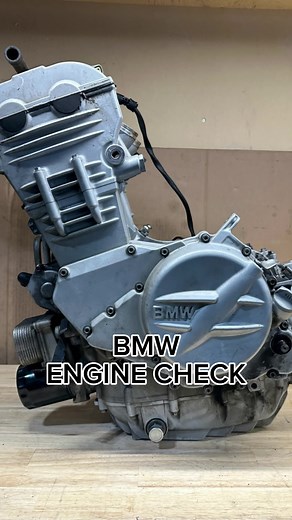 BMW motorcycle engine teardown The bike was making a nasty racket after running for 10-15 minutes (cold, it ran absolutely perfect). Initially I thought it might be the main bearings, or the cam chain/ timing system. So naturally, I drained the oil. Instead of a regular drain bolt, this bike had an aftermarket ball valve fitted to it. I drained the oil to see if there was any discolouration, or bearing material. There wasn't. So I moved onto the cam chain/ timing system. To replace the cam chain