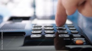 Hand picks up the black (white) phone, dials a number and hangs up