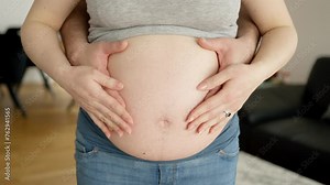 Man touching the belly of a pregnant woman