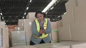 Asian woman fat warehouse worker working checking package products in warehouse. While staff used laser barcode scanner on cardboard box, logistic, placement in storage for shipping.