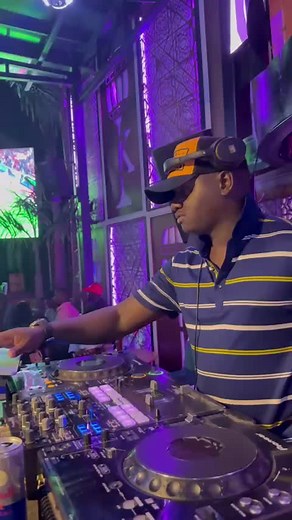 Energetic DJ Performance at a Lively Indoor Event