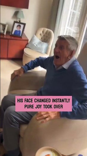great grandfather meets newborn great granddaughter and smiles