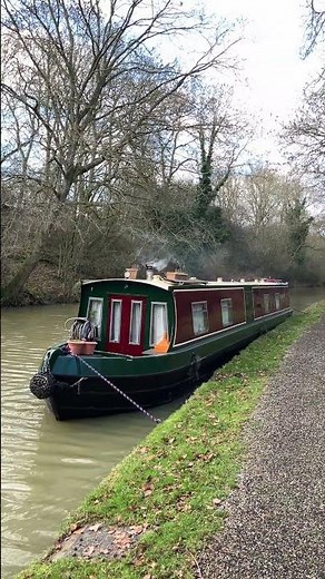 Narrowboat Evenflow with its logburner smoking away moored up on the towpath at Stoke Bruerne #canal
