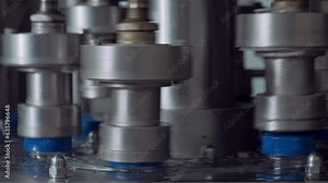 Automated Mechanism Of Industrial Machine Attaching Plastic Caps On Bottles. Automated Cap Sealing Machines Mechanism. Mechanism Of Automated Machine Putting Caps On Milk Bottles. Production Process