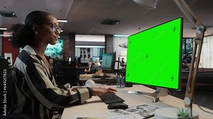 Creative Black Woman Using Desktop Computer with Mock-up Green Screen Chromakey. Female Concept Artist Working in Game Development Company, Creating Immersive Gameplay For New Adventure Video Game.