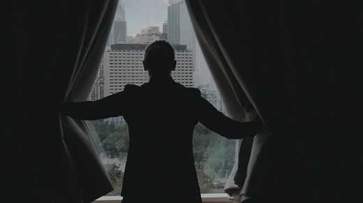 Woman opening dark curtains - Free Stock Video