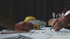 Construction and structure concept of engineer working drawing on blueprint meeting for project working with partner on model building and engineering tools in working site, construction concept.