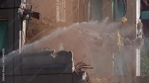 Building demolition with water-based dust suppression