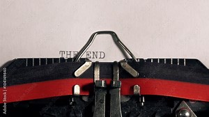 The End on old typewriter, typing text on vintage machine.