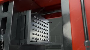 Industrial molding plastic machine operating on the factory conveyor line. Automated machine molding the raw plastic materials. Molding machine creating small eco-friendly plastic pellets.