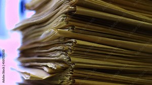 Stack of files in the office, on a desk.