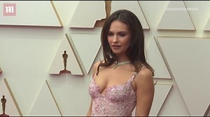 Lily James pretty in pink floral lace gown on the 2022 Academy Awards red carpet