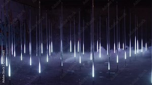 Creative and conceptual art installation of multiple led pillars or columns being lit up in synchronization in darkness with white light. Concept futuristic performance or artsy inspiration