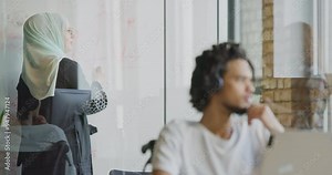 A diverse group of colleagues collaborates using laptops, mobiles, and tablets to tackle business challenges and enhance productivity through teamwork and innovative technology.