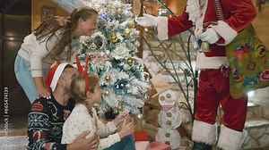Santa Claus arriving to visit family with child at home Stock Video