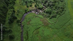 Aerial footage of the Loup of Fintry waterfall, near the village of Fintry in Central Scotland. People wild-water swimming in the pools at the bottom of the cascade.