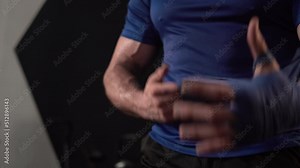Strong boxer man wrap hands protection knuckle, Man is wrapping hands with boxing wraps for training and active exercise
