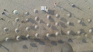 Sunny tourism beach, zoom out aerial shot - Free Stock Video