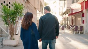 Man and woman couple hugging each other standing at street
