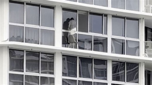 Daredevil window washer dances with death on high-rise apartment ledge