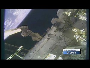Spacewalker moved by robotic arm in amazing space view