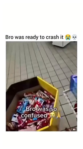 @gearheadgiggle on Instagram: "The video captures a brief but tense interaction at a checkout counter in a store. The scene opens with a yellow box filled with various candy bars prominently displayed on the counter. A man in a blue shirt, presumably the cashier, stands behind the counter as a customer hands him several lottery tickets. The customer continues to hand over more lottery tickets along with some cash. The cashier proceeds to scan the lottery tickets using a barcode scanner attached 