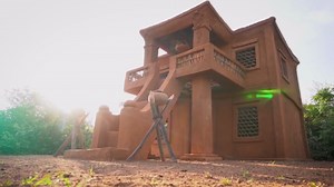 A Magical Hand Built Dragon King Sculpture Rising From a Mud House in the Jungle