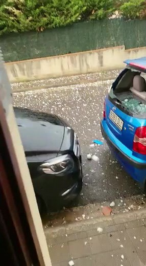 Hailstorm Aftermath: Damage to Black Car Revealed