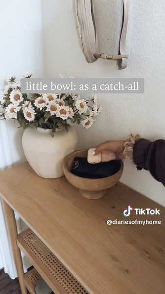 FLASHBACK FRIDAY to this small entry idea! we don’t have a mudroom or drop zone like we used to have back in our old home back in Iowa so I had to make use of the smaller space we had here 😌 added hooks for coats/sweaters cane console from Target that is under $200 and in-stock now! washable runner some decorative items on top #interiorinspo #smallspaces #entrywaydecor #shoestorage #storagesolution #entryway #foyer