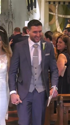 bride and groom walk down the aisle